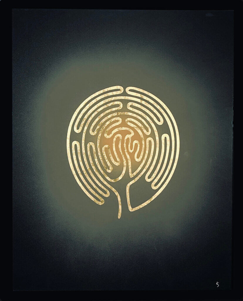 Goldenes Labyrinth-Design auf schwarzem Hintergrund, symbolisiert innere Reise und Meditation.